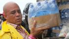 PHOTO: President Martelly carry case of Water